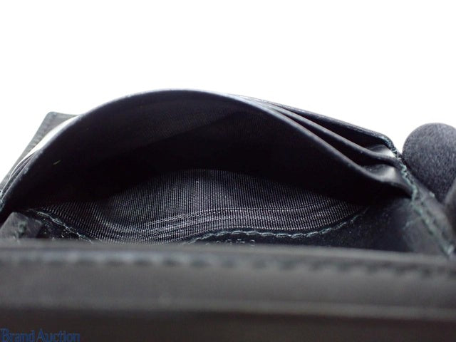 CURATED by Kira Gucci Guccissima black leather bi-fold wallet interior view showing card slots and fabric lining