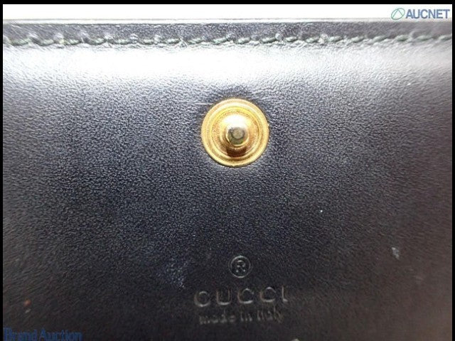 CURATED by Kira Gucci black leather bi-fold wallet featuring a gold-tone snap button closure and embossed logo