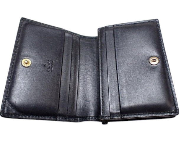 CURATED by Kira black Gucci Guccissima bi-fold wallet with interior card slots and gold-tone snap button closure