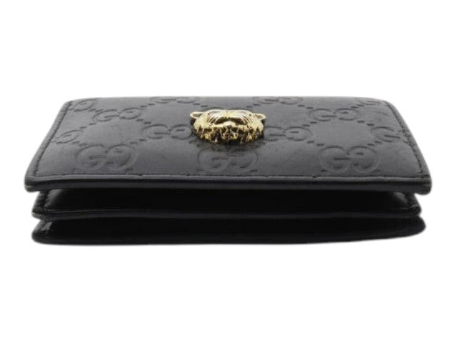 CURATED by Kira black Gucci Guccissima leather bi-fold wallet featuring a gold-tone metal cat head emblem