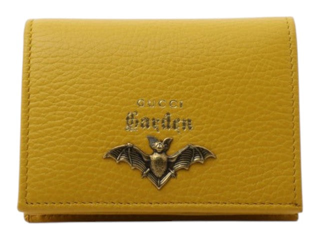 CURATED by Kira Gucci Garden small yellow leather wallet featuring a metallic bat emblem and gold embossed logo