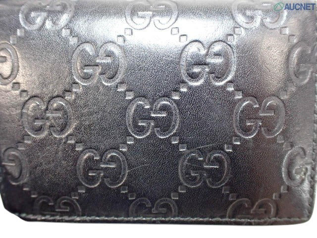 CURATED by Kira black Gucci Guccissima leather bi-fold wallet featuring embossed GG logo pattern