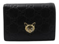 CURATED by Kira black Gucci Guccissima leather bi-fold wallet featuring a gold-tone metal cat head emblem.