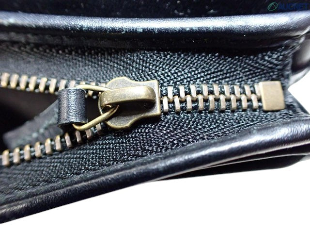 CURATED by Kira Gucci Guccissima bi-fold wallet featuring a detailed brass zipper pull on black leather