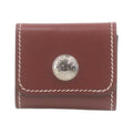 CURATED by Kira Hermes maroon leather notepad with silver button detail and white contrast stitching
