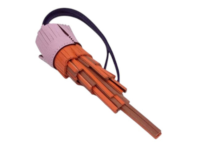 CURATED by Kira Hermes Chouette Agneau Milo owl charm in orange, pink, and brown leather with a purple strap.