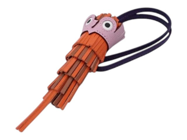 CURATED by Kira Hermes Chouette Agneau Milo owl charm in orange and brown leather with a purple strap