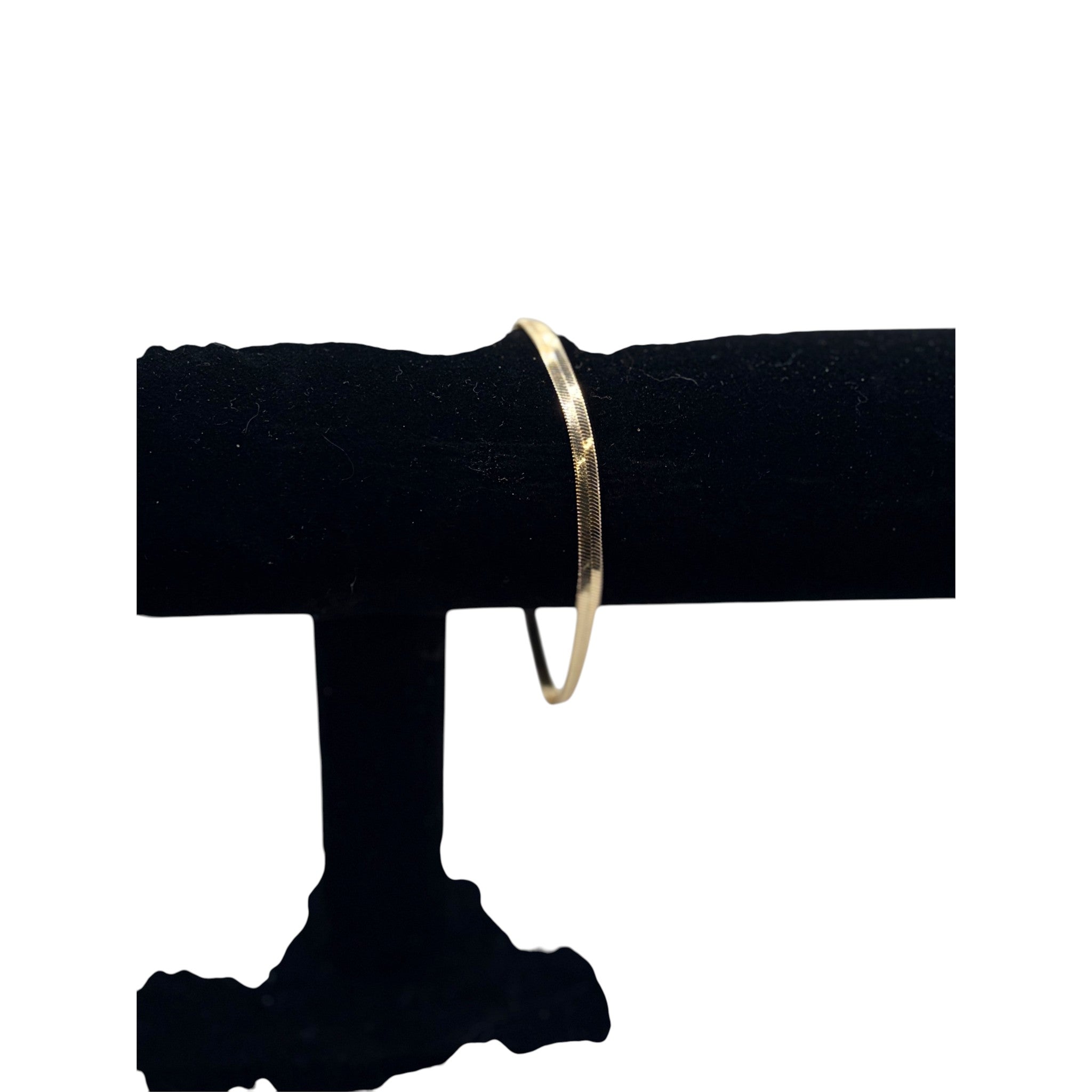 CURATED by Kira Kate Spade gold tone herringbone chain bracelet on a black display stand