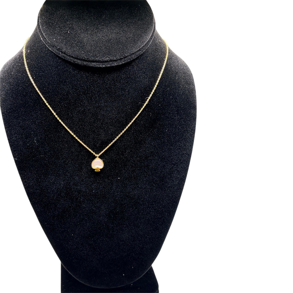CURATED by Kira Kate Spade New York gold chain necklace featuring a mother of pearl spade pendant on a black bust