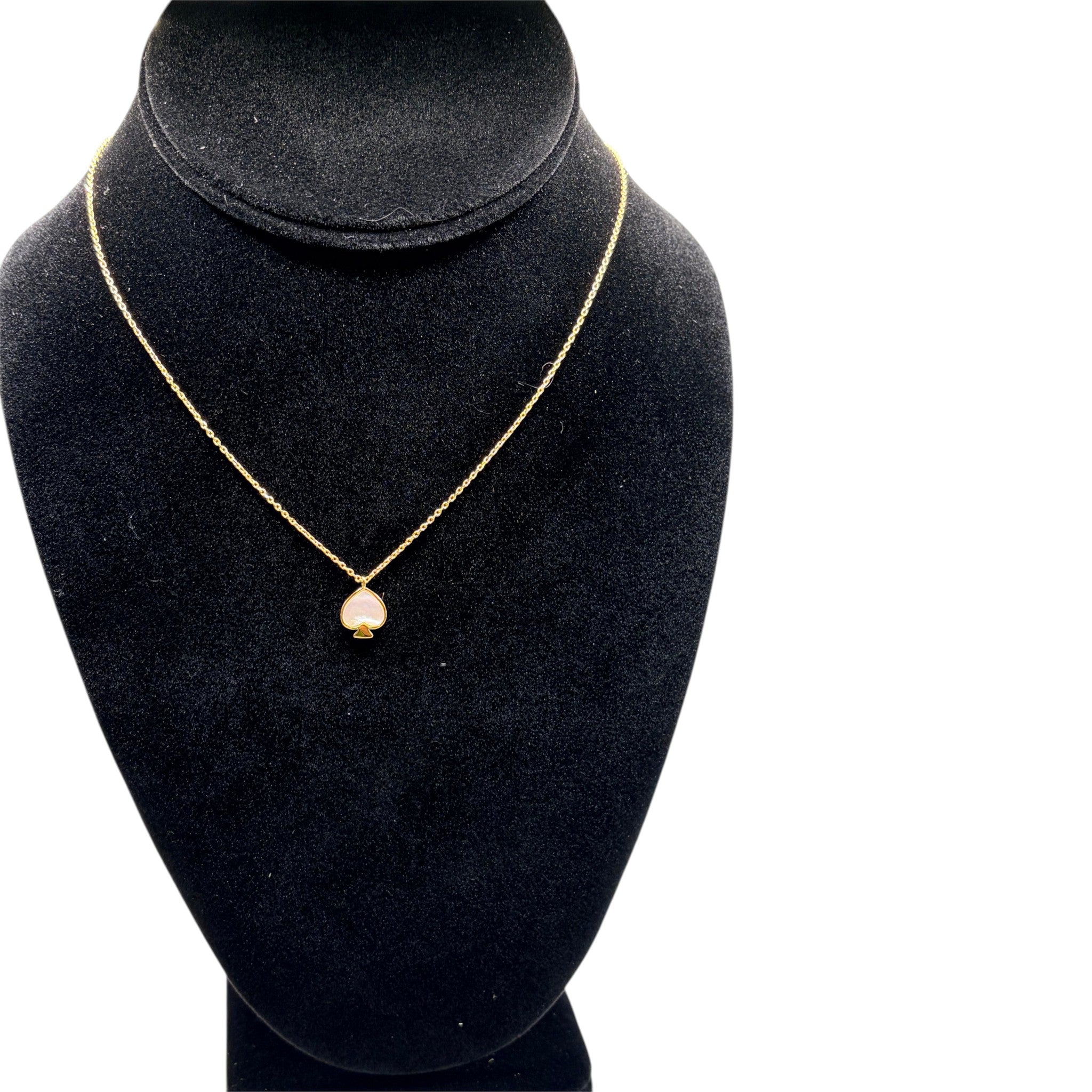 CURATED by Kira Kate Spade New York gold chain necklace featuring a mother of pearl spade pendant on a black bust
