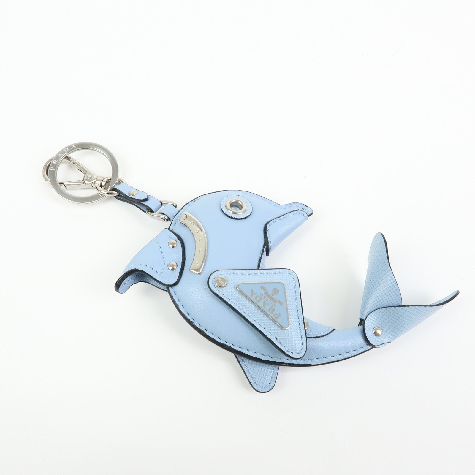 CURATED by Kira light blue Saffiano leather dolphin charm keychain with Prada triangle logo detail.