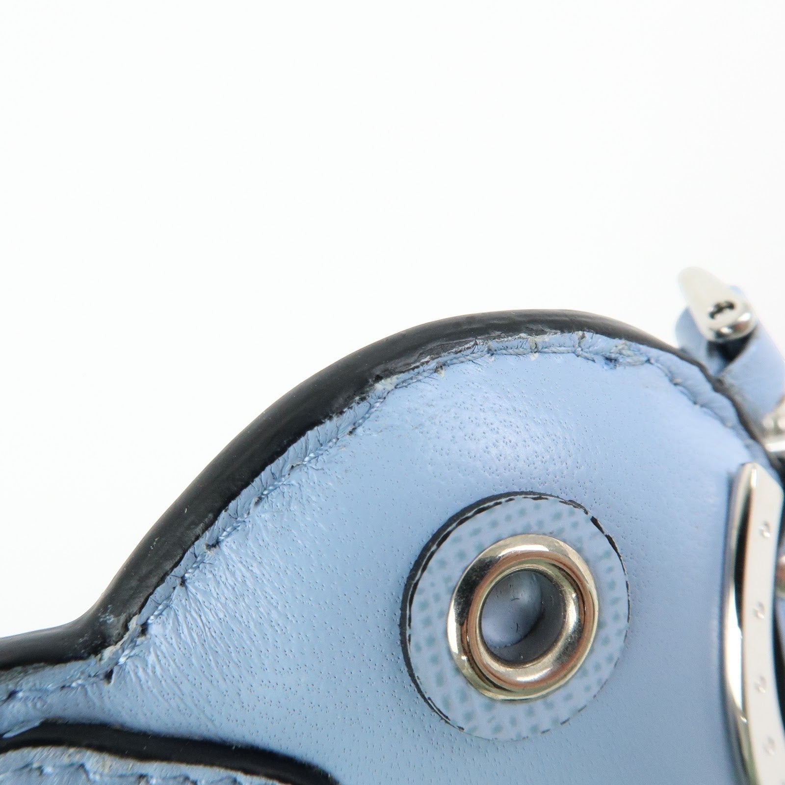 CURATED by Kira light blue Saffiano leather dolphin charm with silver-tone hardware and triangle logo detail.