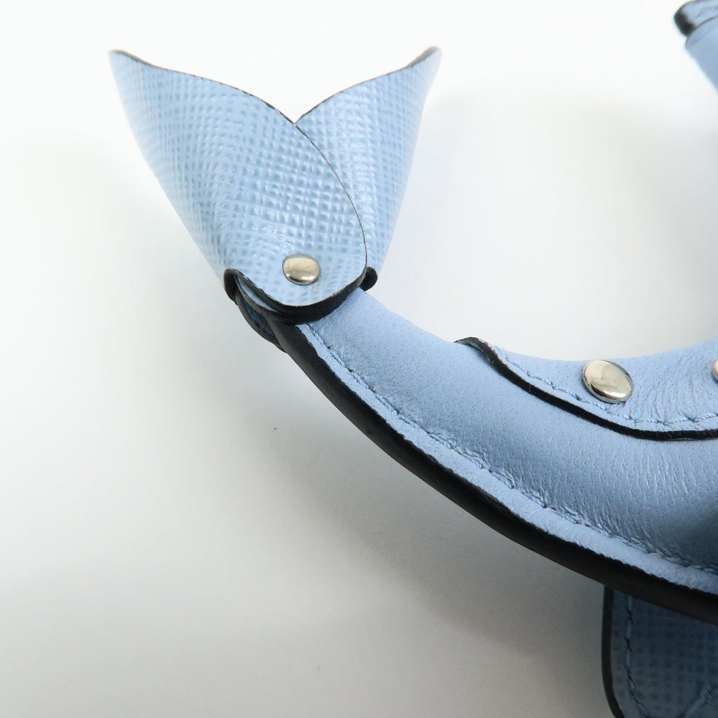 CURATED by Kira light blue Saffiano leather dolphin charm with silver hardware and triangle logo detail.
