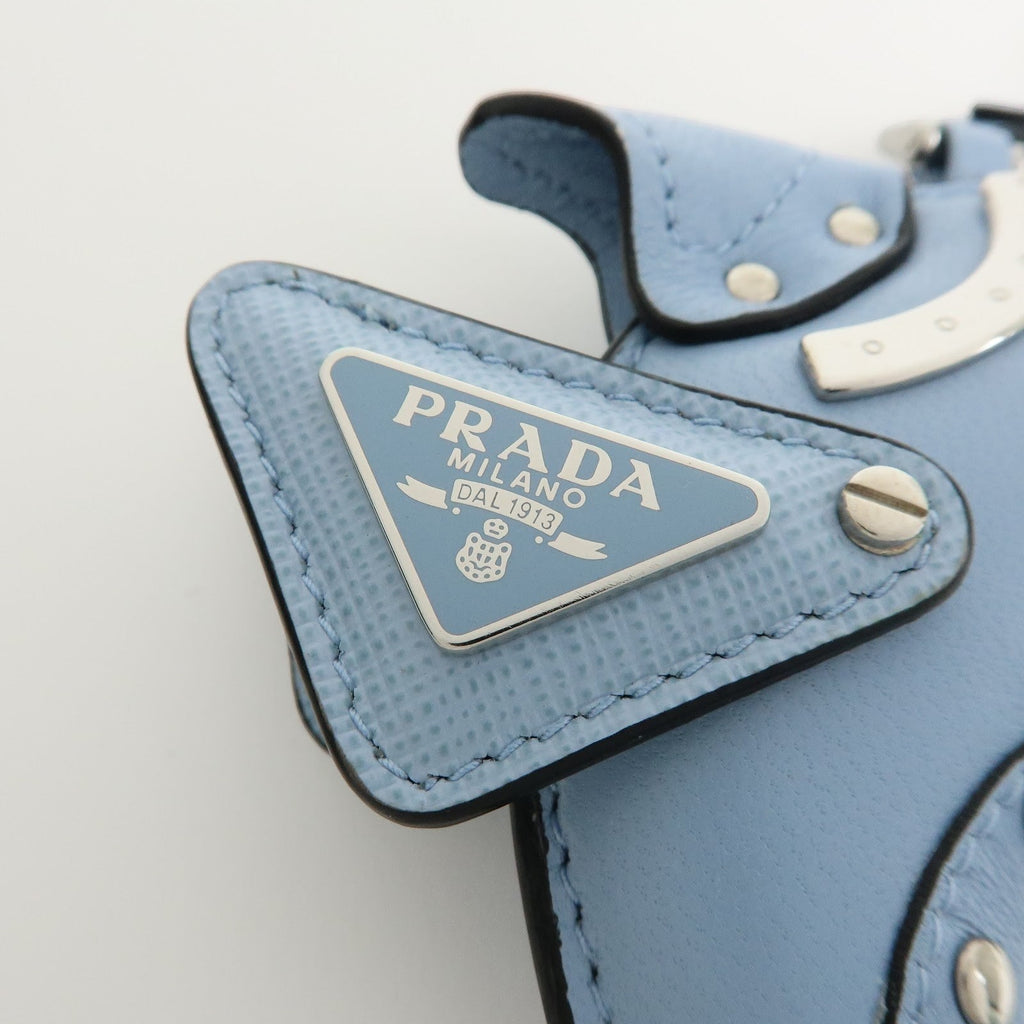 CURATED by Kira light blue Saffiano leather Prada dolphin charm keychain with silver triangle logo detail.