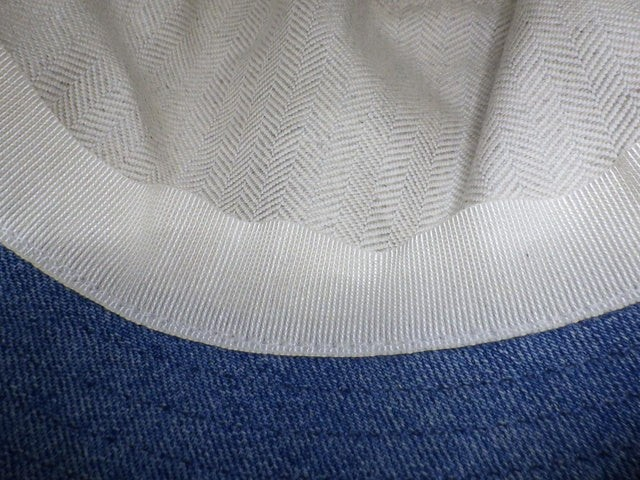 CURATED by Kira Loewe denim blue hat interior detail showing white herringbone lining and grosgrain ribbon trim