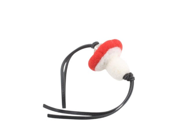 CURATED by Kira Loewe mushroom bag charm keychain in red and white felt with black leather straps.