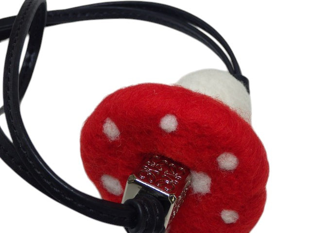 CURATED by Kira Loewe red and white felt mushroom bag charm with white polka dots and silver hardware.