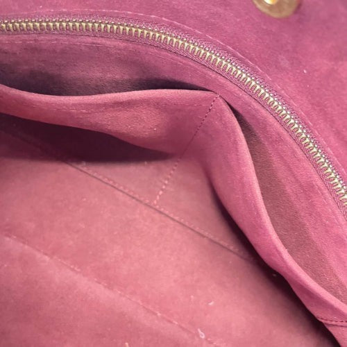 Interior view of CURATED by Kira Louis Vuitton Carryall PM bag featuring a deep burgundy suede lining and zipper