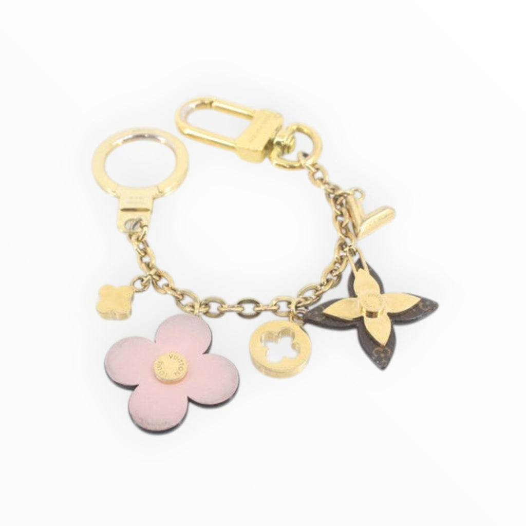 CURATED by Kira Louis Vuitton Bijou Sac Chaine Blooming Flower bag charm in gold with pink and monogram accents.