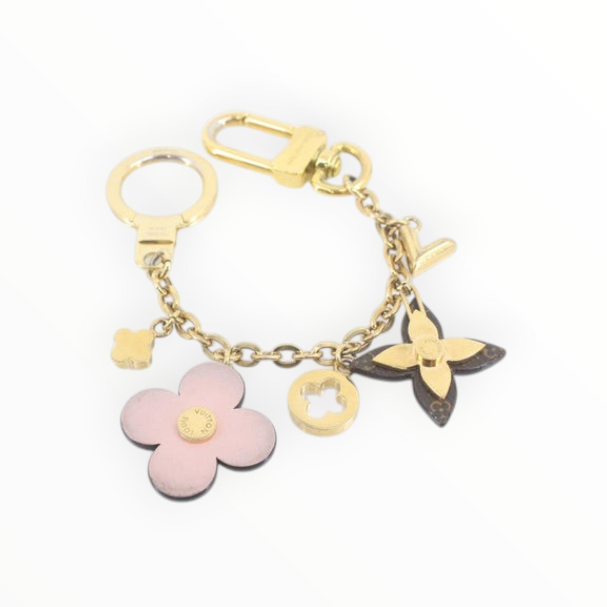 CURATED by Kira Louis Vuitton Bijou Sac Chaine Blooming Flower bag charm in gold with pink and monogram accents.
