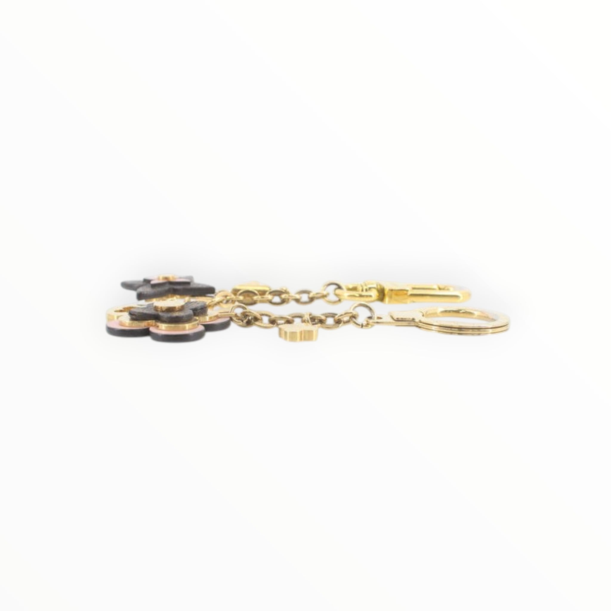 CURATED by Kira Louis Vuitton Blooming Flower bag charm and keychain in gold-tone metal with black floral accents