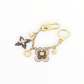 CURATED by Kira Louis Vuitton Blooming Flower bag charm and keychain in gold with signature monogram canvas accents