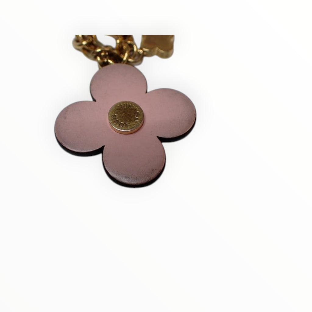 CURATED by Kira Louis Vuitton Blooming Flower bag charm in pink and gold with a central engraved logo stud