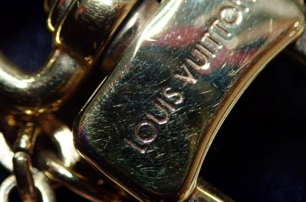 CURATED by Kira Louis Vuitton M63086 gold metal charm with engraved logo detail