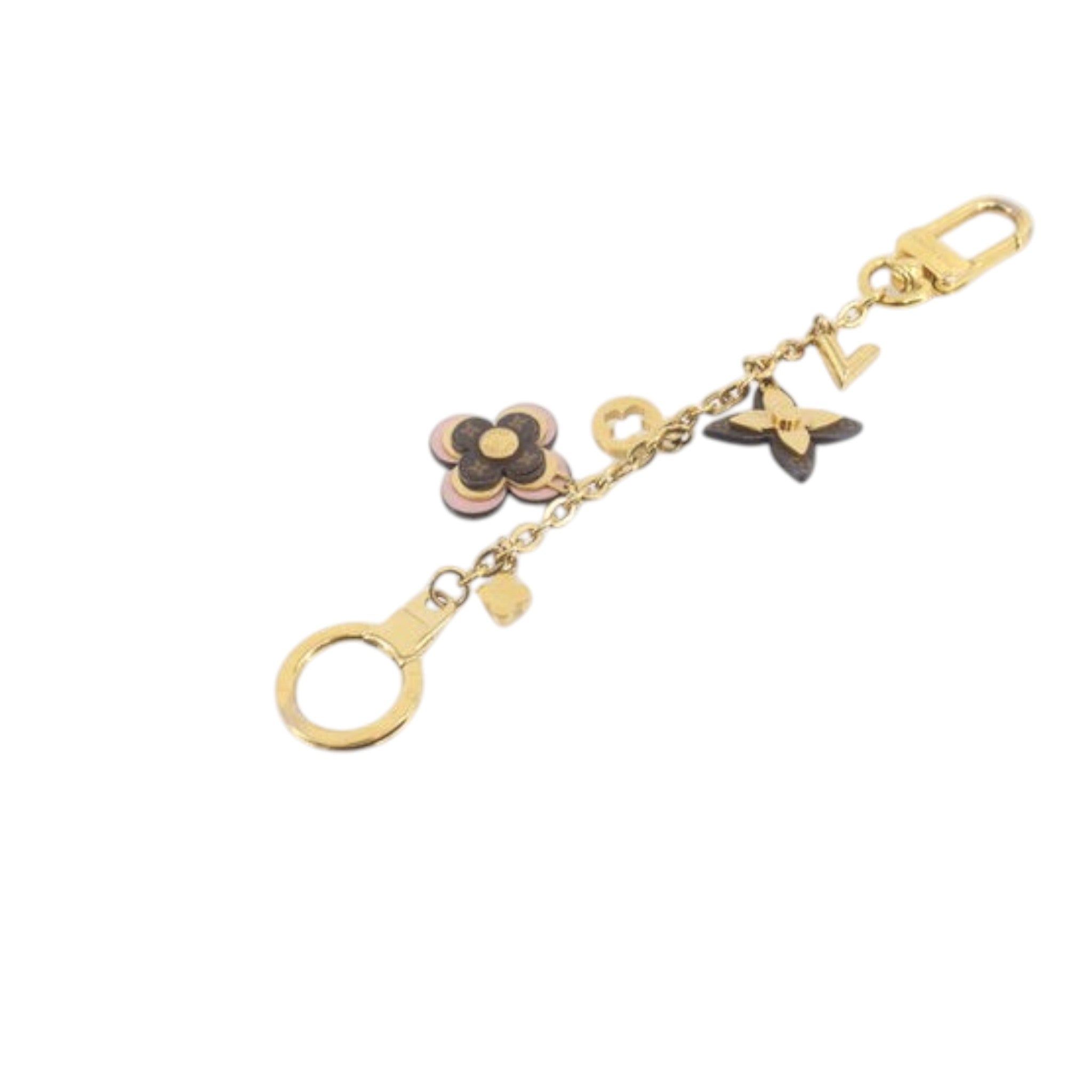 CURATED by Kira Louis Vuitton M63086 gold charm featuring iconic monogram flower and LV logo accents
