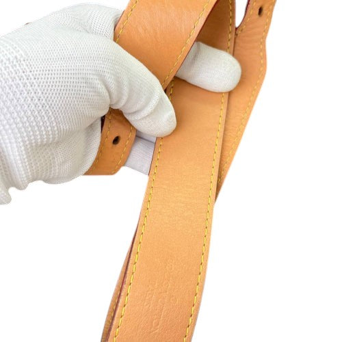 CURATED by Kira Louis Vuitton Carryall PM brown leather strap with yellow stitching held by a gloved hand