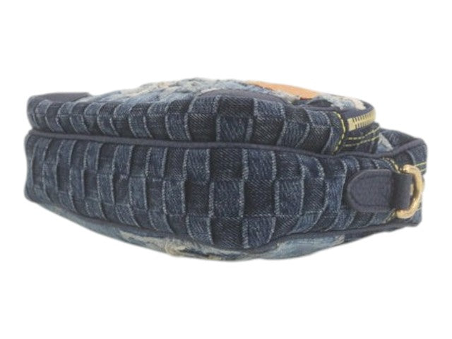 CURATED by Kira Louis Vuitton Nigo Monogram denim bag in blue with woven texture and gold hardware side view