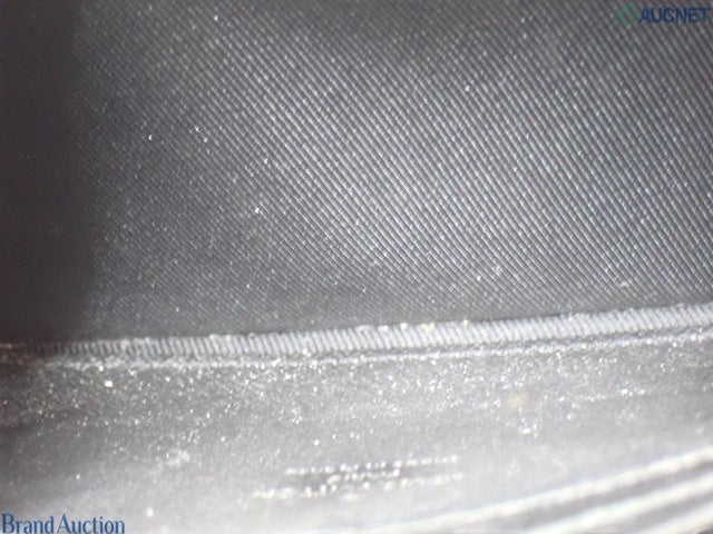 Interior lining of a brown Louis Vuitton Zipped Pouch MM M67814 from CURATED by Kira showing the embossed logo.