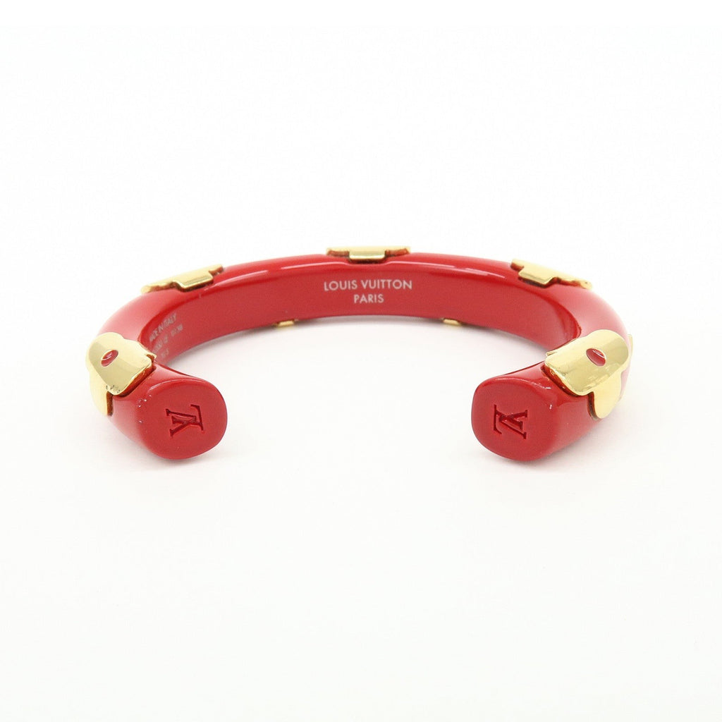 CURATED by Kira Louis Vuitton Paris red resin and gold-tone metal bangle bracelet with engraved LV logo.