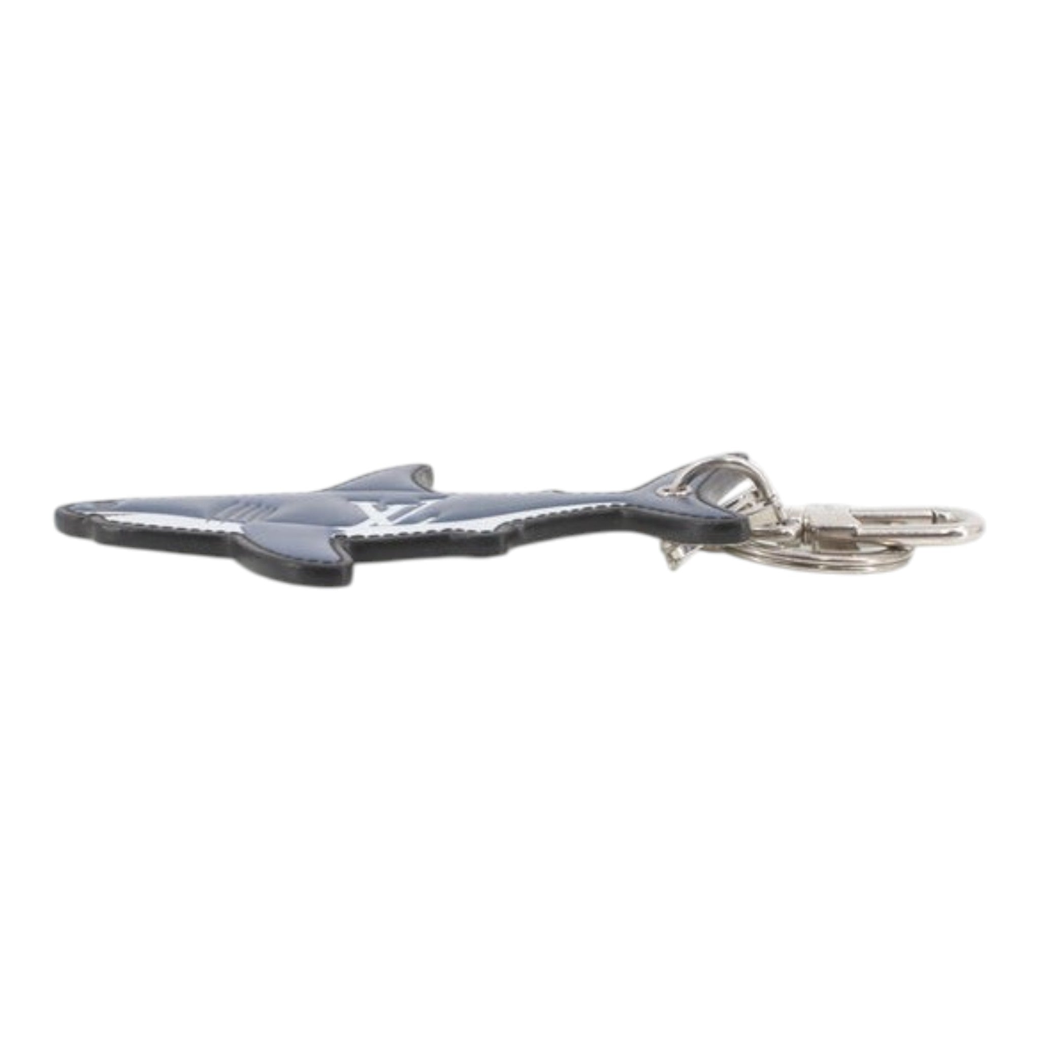 CURATED by Kira Louis Vuitton shark-shaped keychain in blue leather with silver hardware, side view.