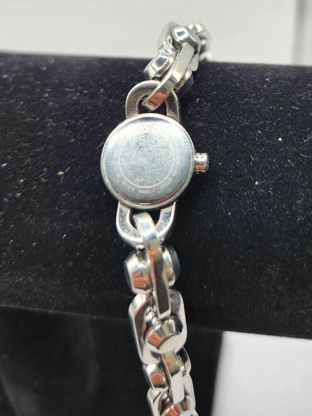 CURATED by Kira Michael Kors Astor silver stainless steel watch showing the round case back and chain-link bracelet