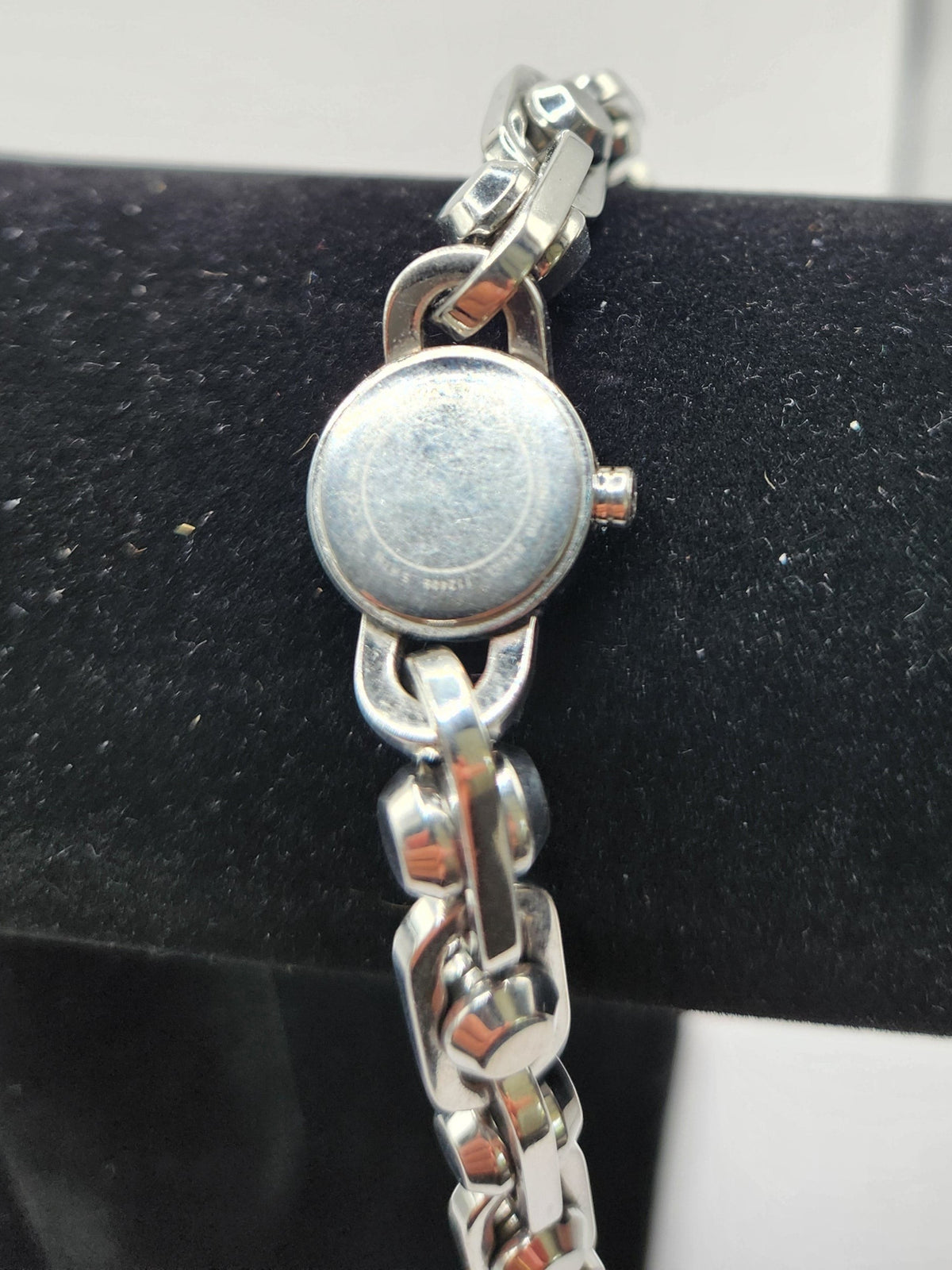 CURATED by Kira Michael Kors Astor silver stainless steel watch showing the round case back and chain-link bracelet