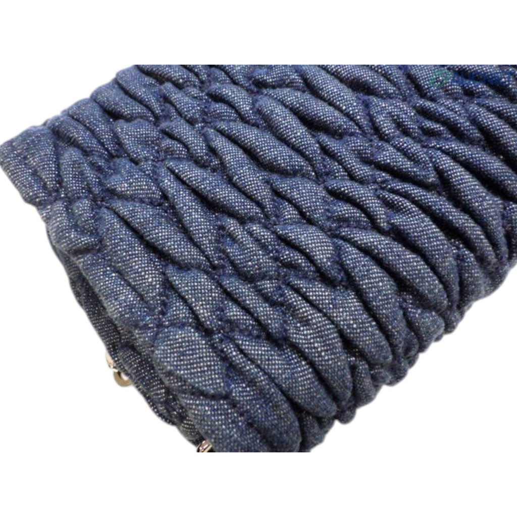 CURATED by Kira Miu Miu navy denim matelassé bag featuring a textured quilted pattern and silver turn lock hardware.