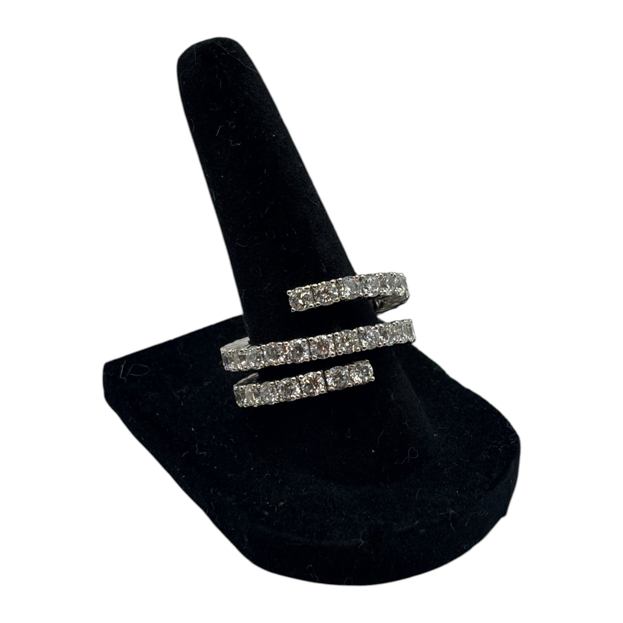 CURATED by Kira Nadri silver tone double row CZ eternity band ring on a black velvet display stand