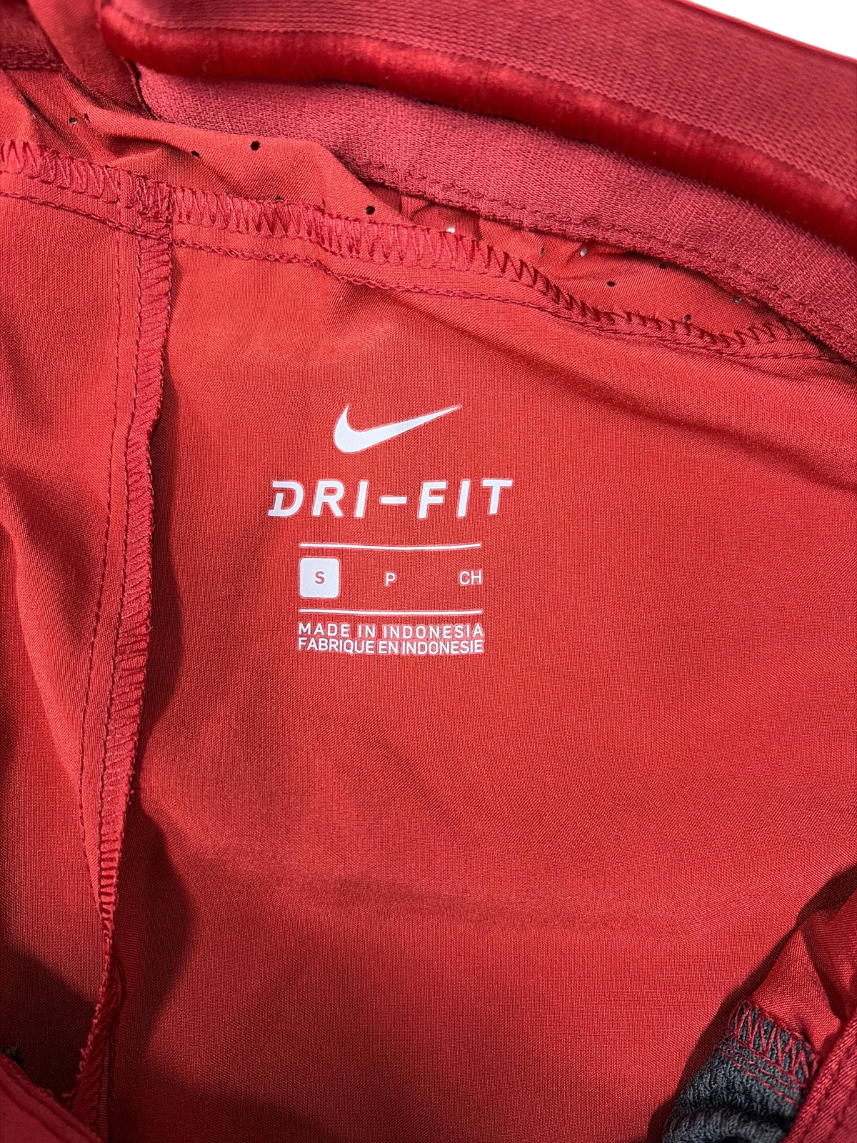 CURATED by Kira Nike Dri-FIT cardinal red athletic track pants interior label with size small tag