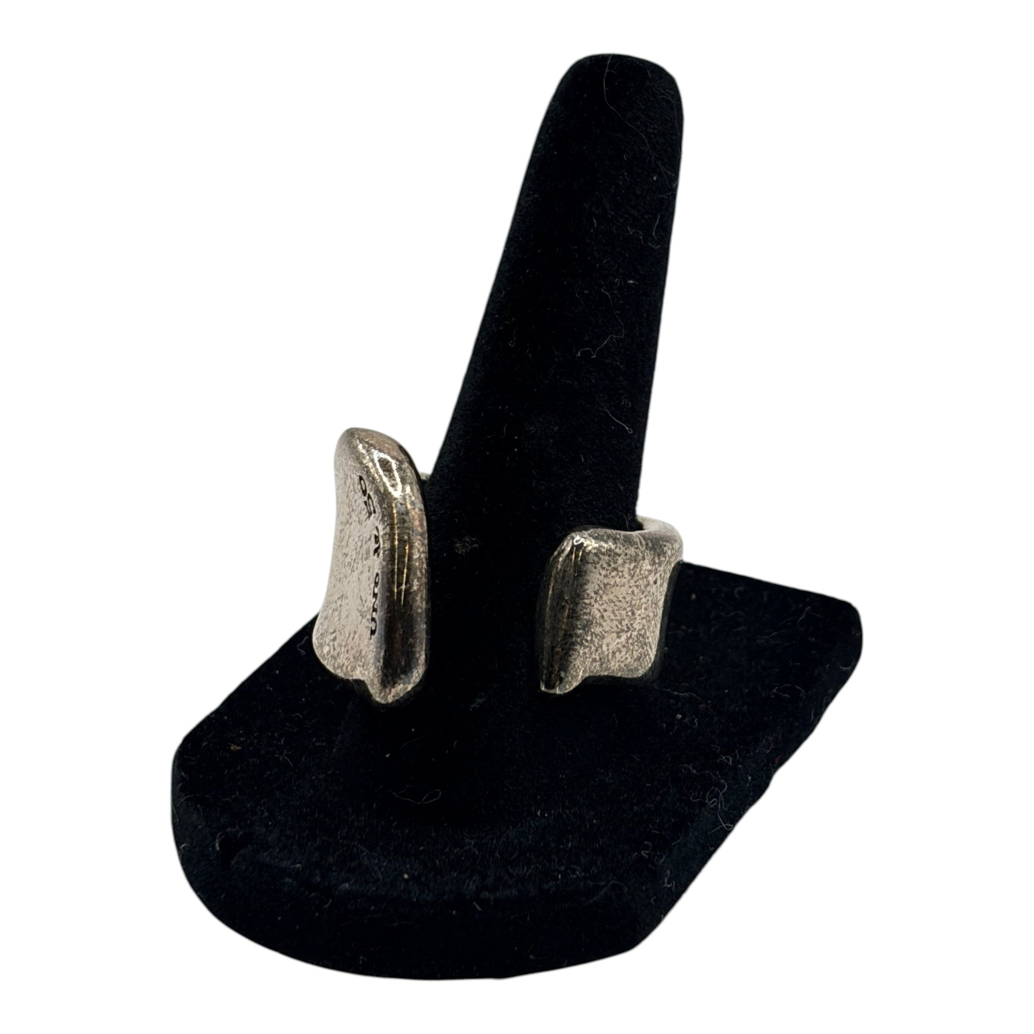 CURATED by Kira oxidized silver chunky organic freeform ring with an open design on a black velvet display stand.
