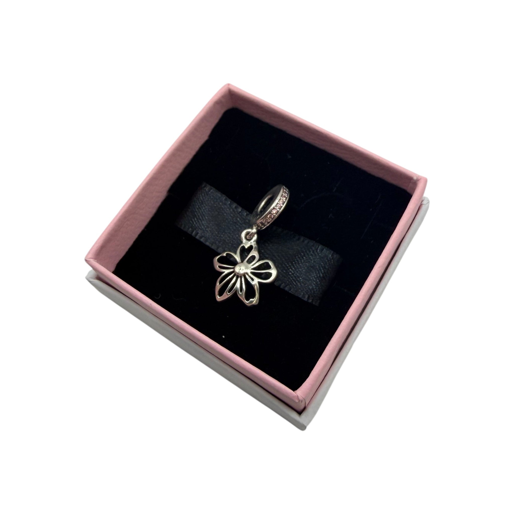 CURATED by Kira Pandora sterling silver daisy flower dangle charm displayed in a pink and black gift box