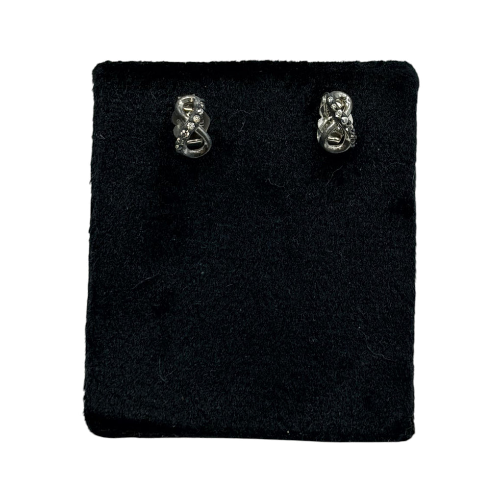 CURATED by Kira Pandora sterling silver infinity knot stud earrings with sparkling CZ stones on a black display pad
