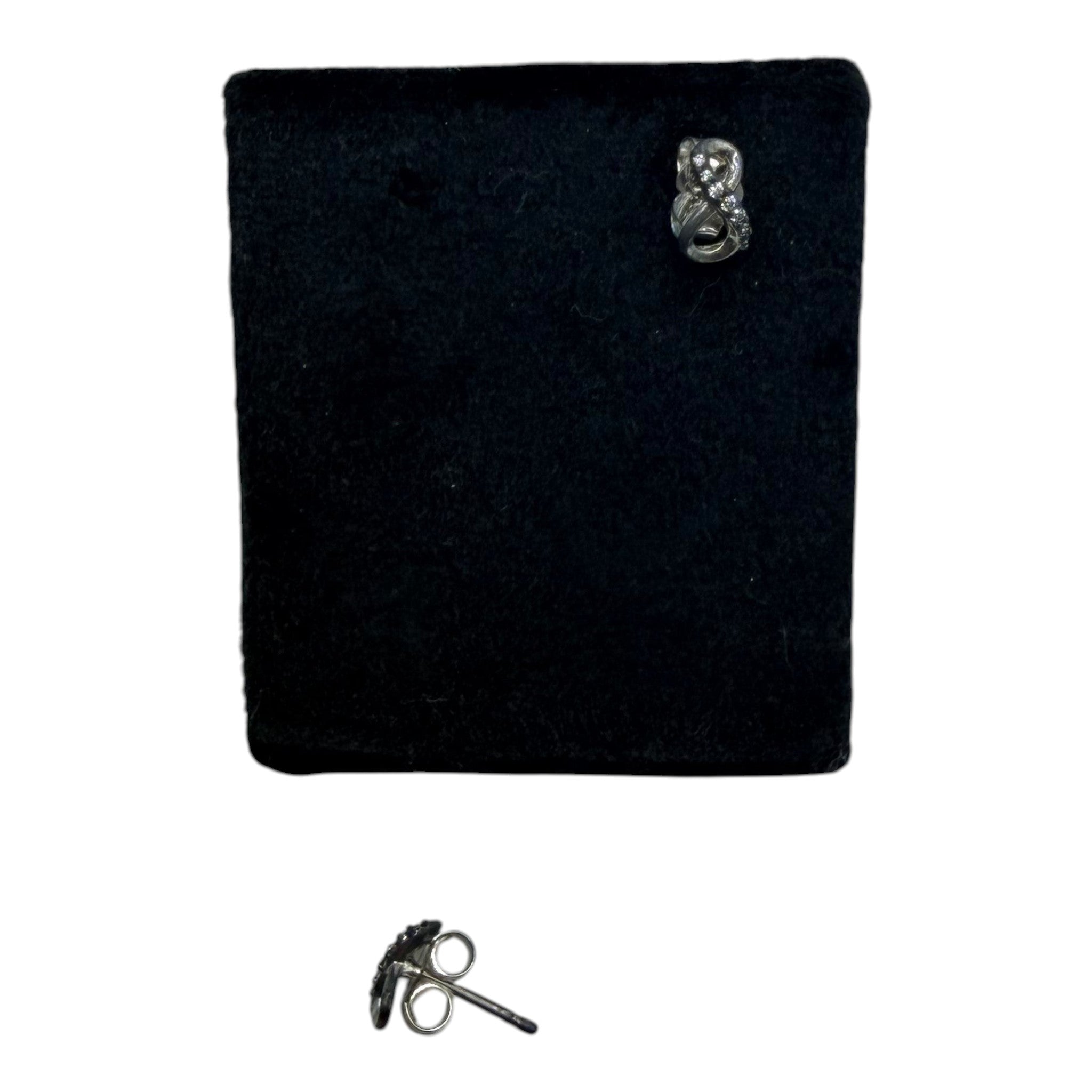 CURATED by Kira Pandora sterling silver infinity knot stud earrings with cubic zirconia stones on black display