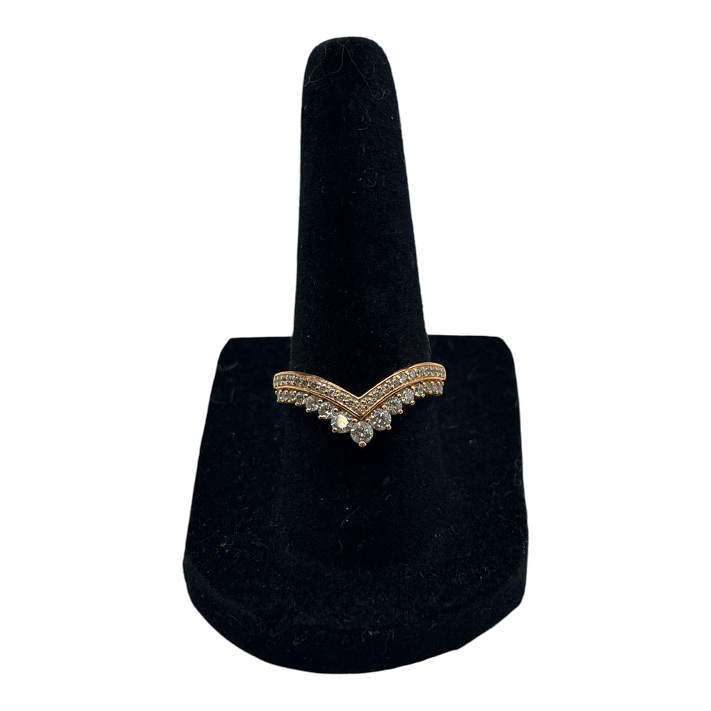 CURATED by Kira Pandora Princess Wishbone ring in 14k rose gold plating with sparkling pavé stones on a black stand