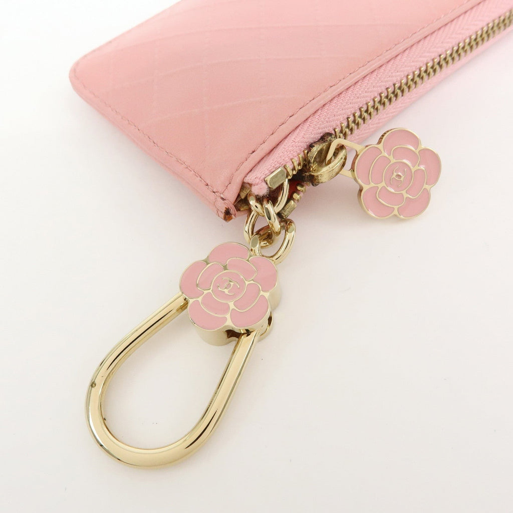 CURATED by Kira pink quilted leather zip-around card holder with floral charm and gold hardware.