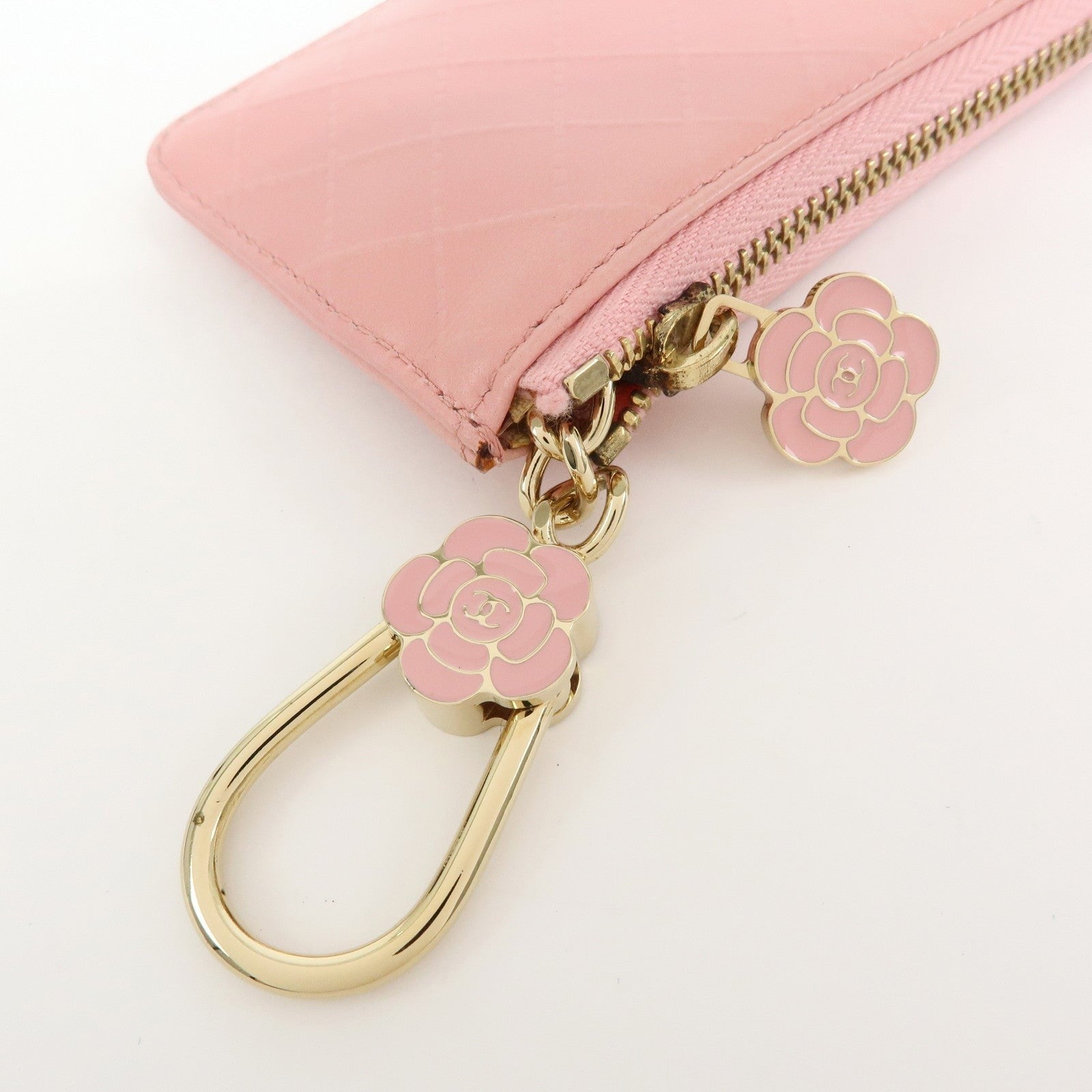 CURATED by Kira pink quilted leather zip-around card holder with floral charm and gold hardware.