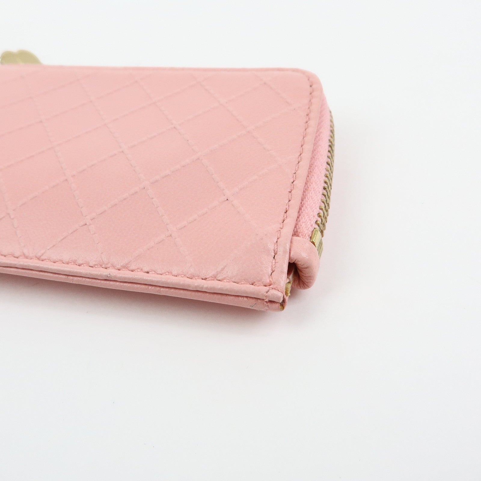 CURATED by Kira pink quilted leather zip-around card holder with floral charm detail.