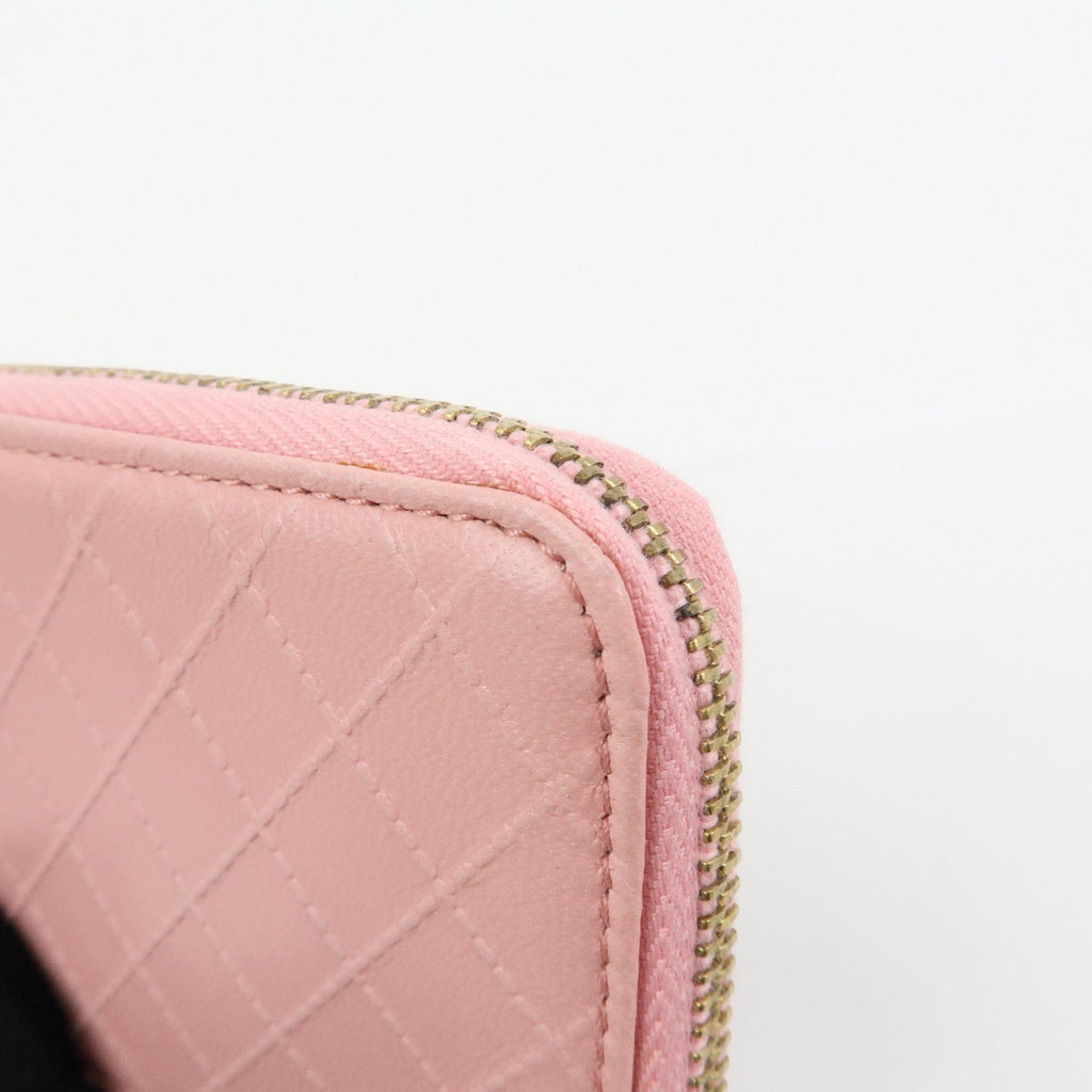 CURATED by Kira pink quilted leather zip-around card holder with gold-tone zipper and floral charm.