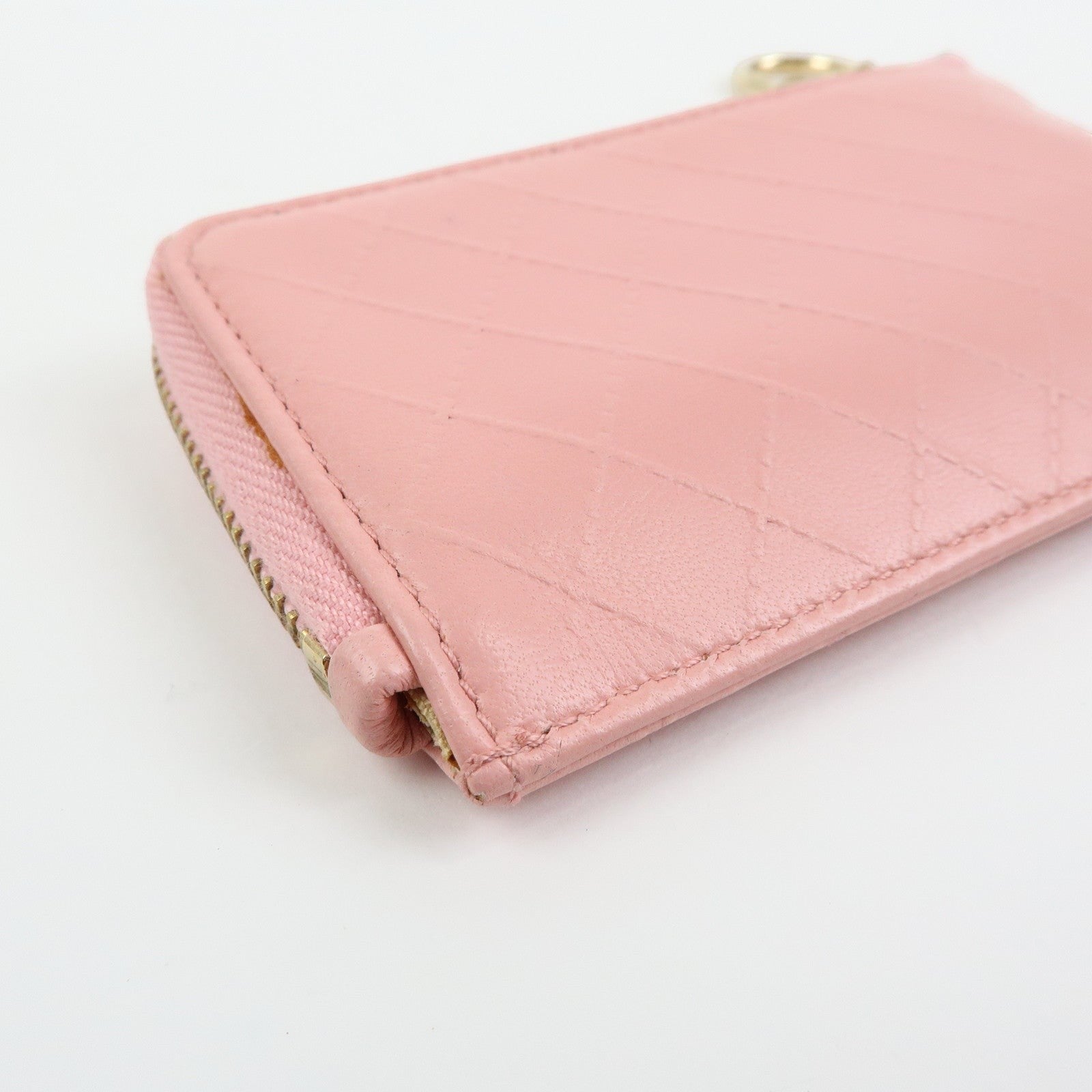 CURATED by Kira pink quilted leather zip-around card holder with floral charm and gold-tone hardware.