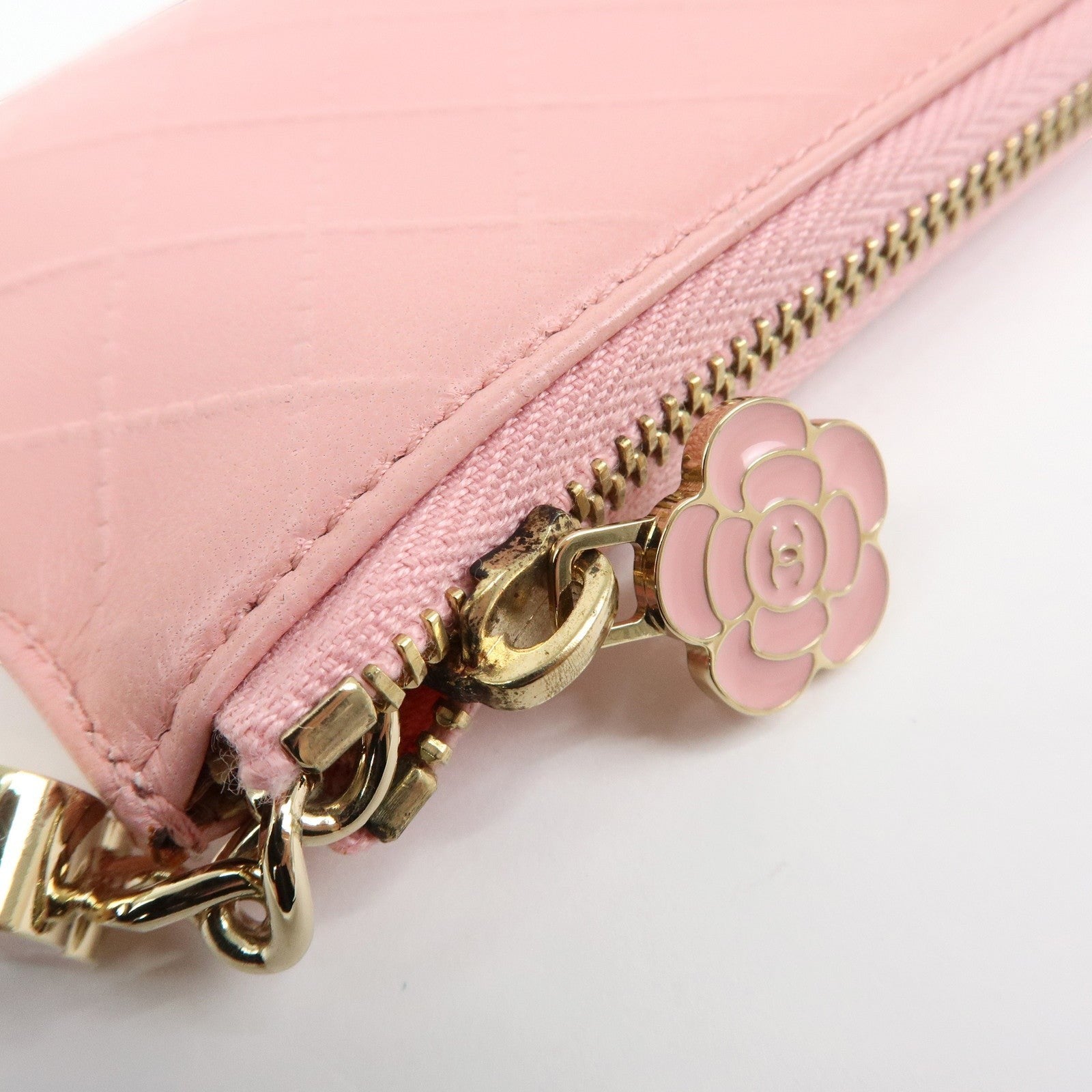 CURATED by Kira pink quilted leather zip-around card holder with floral charm and gold hardware.